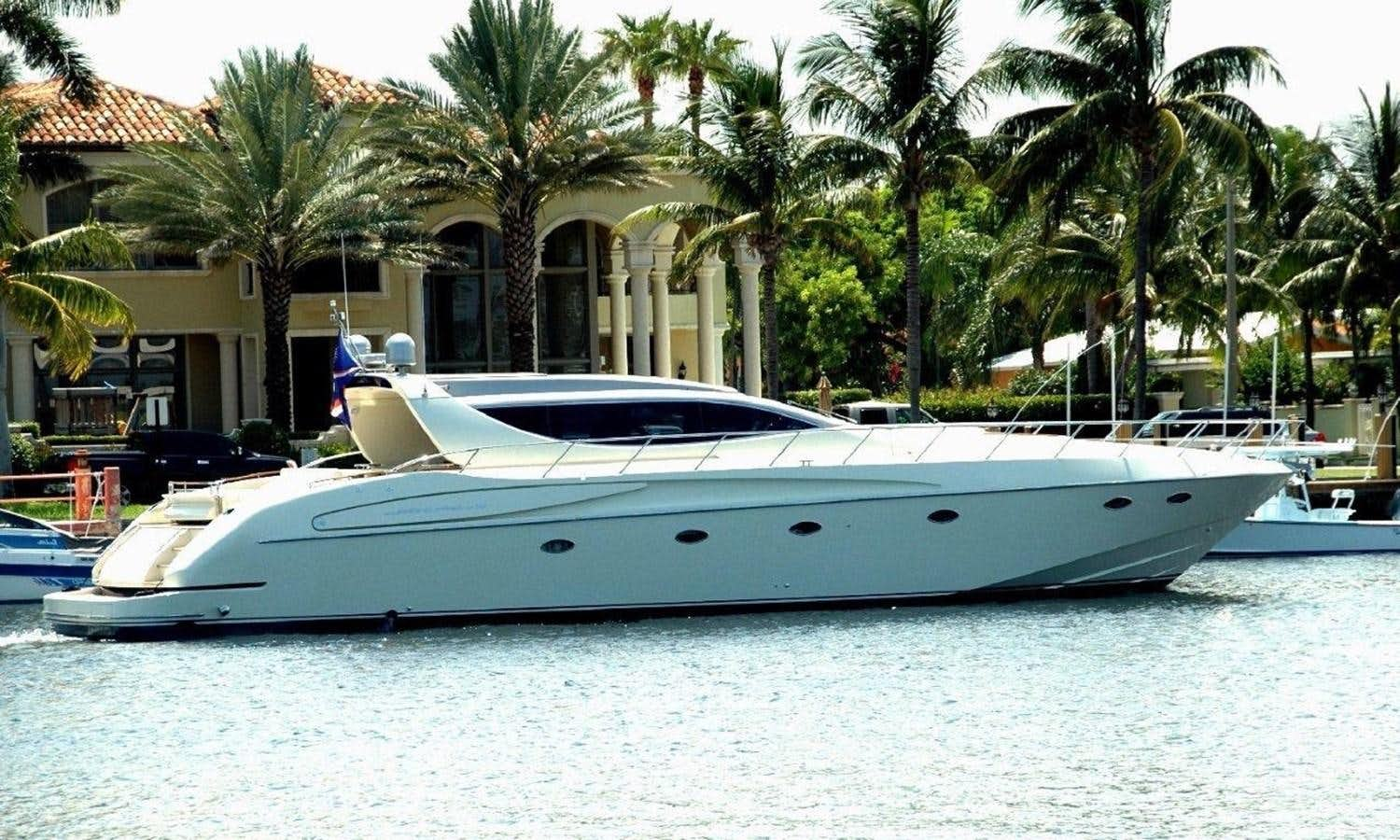 a white yacht in a tropical resort aboard BON VIVANT Yacht for Sale