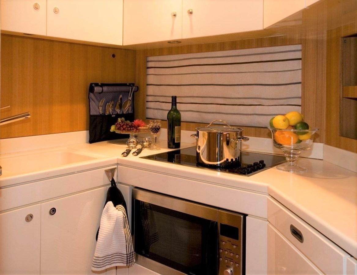 a kitchen with a stove and a microwave aboard BON VIVANT Yacht for Sale