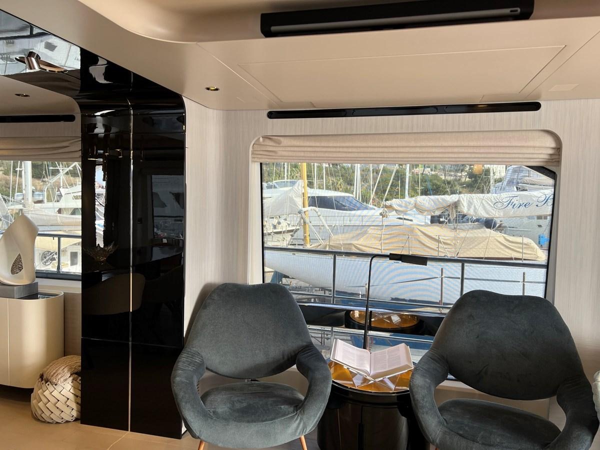 a room with a window and a chair aboard QUEEN ANA Yacht for Sale