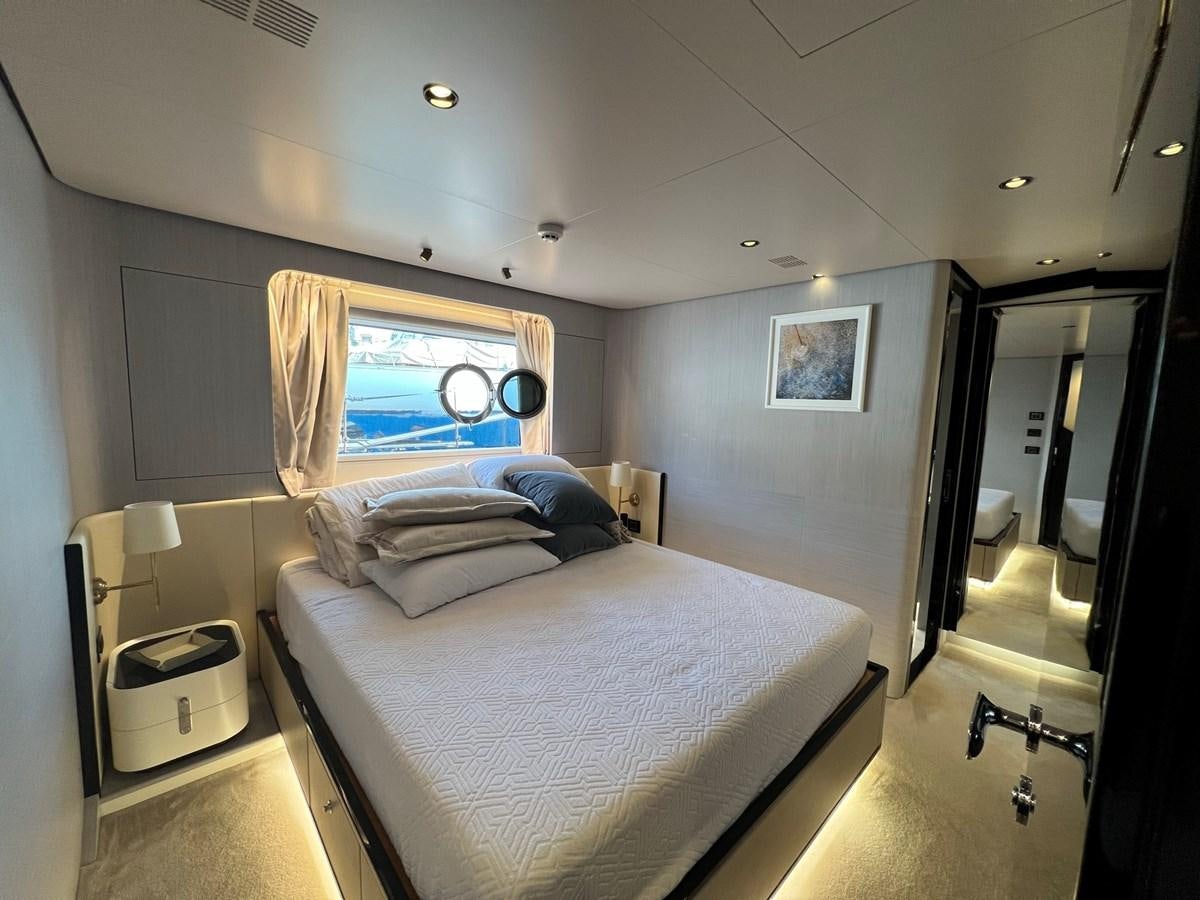a bedroom with a bed and a window aboard QUEEN ANA Yacht for Sale