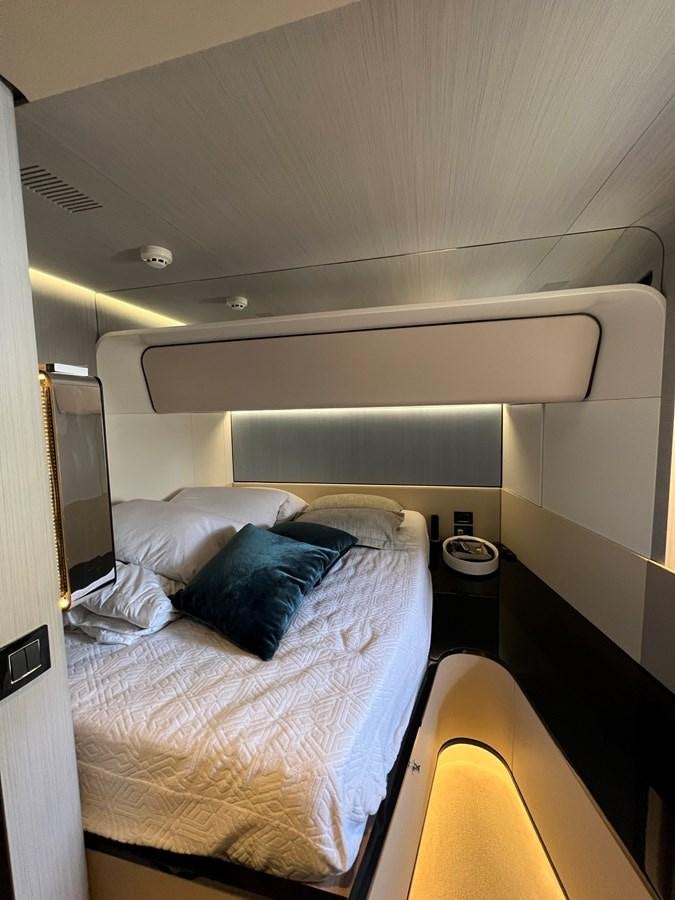 a bed with a white sheet and a white pillow aboard QUEEN ANA Yacht for Sale