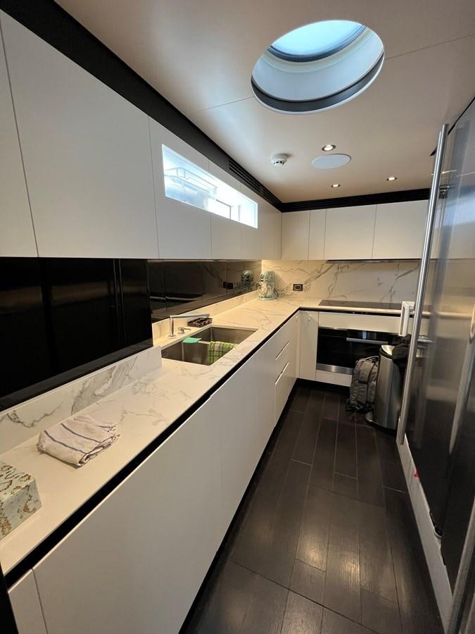 a kitchen with a large island aboard QUEEN ANA Yacht for Sale