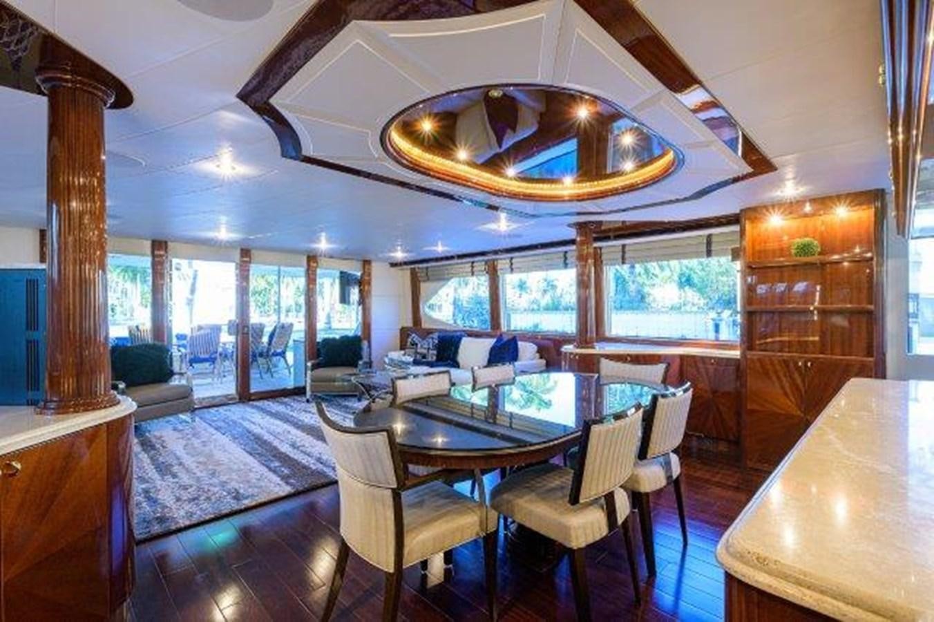 a large room with a table and chairs aboard SUZANNE Yacht for Sale