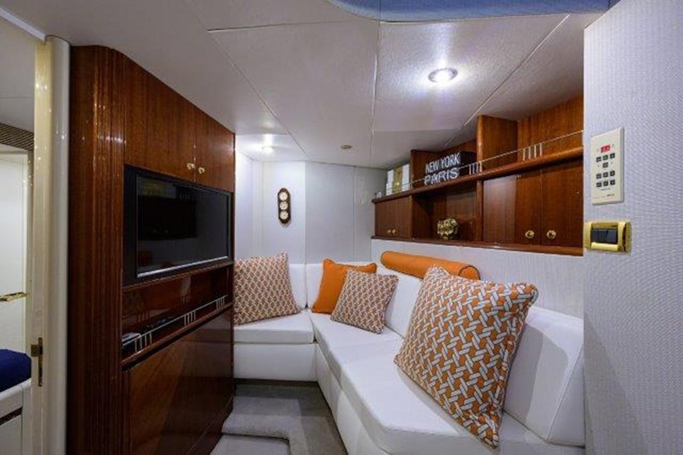 a room with a couch and a television aboard SUZANNE Yacht for Sale