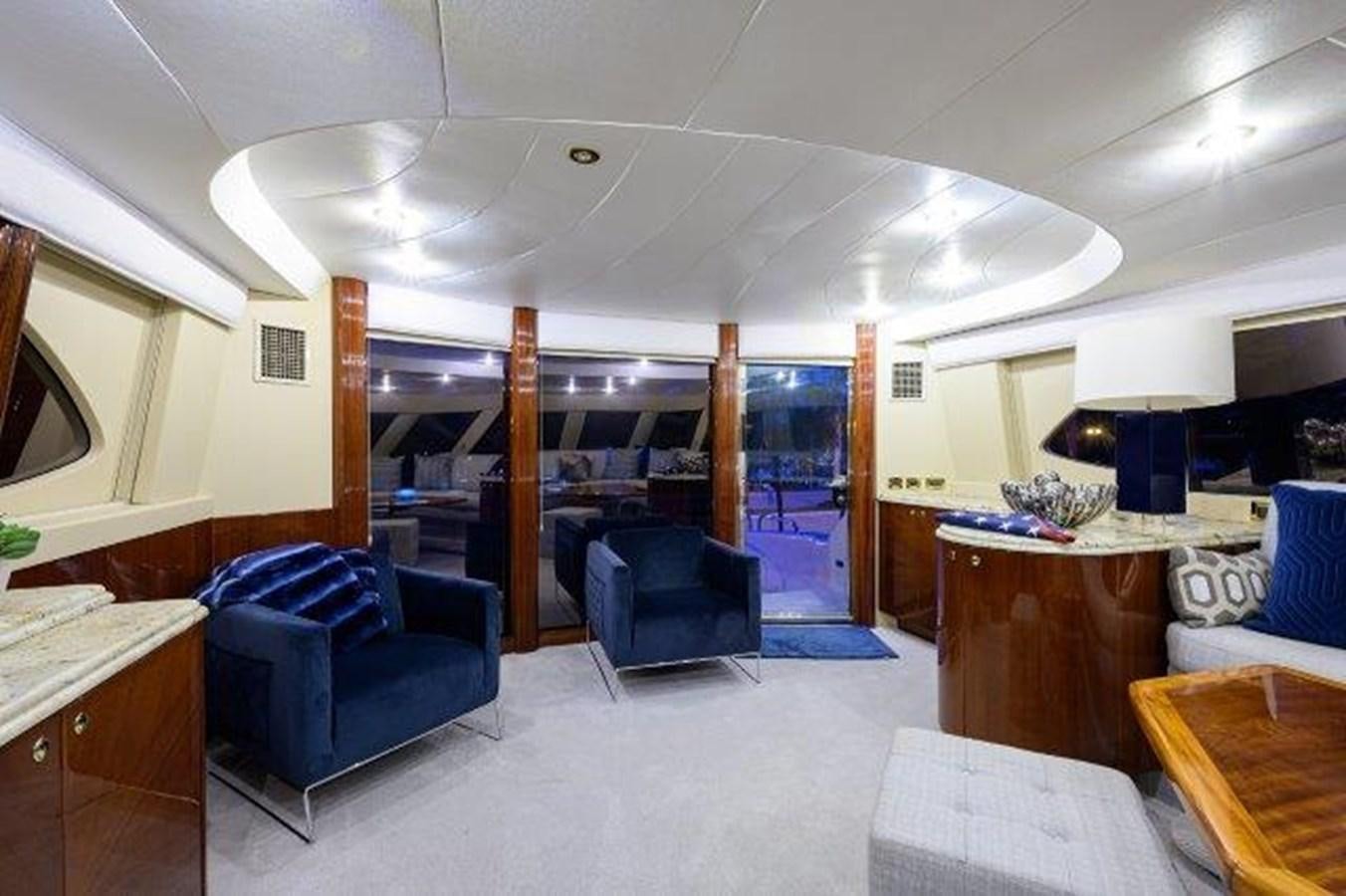 a room with a blue chair and a table and a blue chair aboard SUZANNE Yacht for Sale