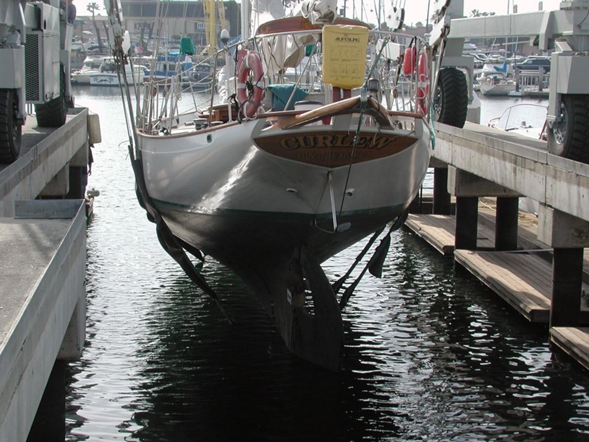 a boat docked at a pier aboard CURLEW Yacht for Sale