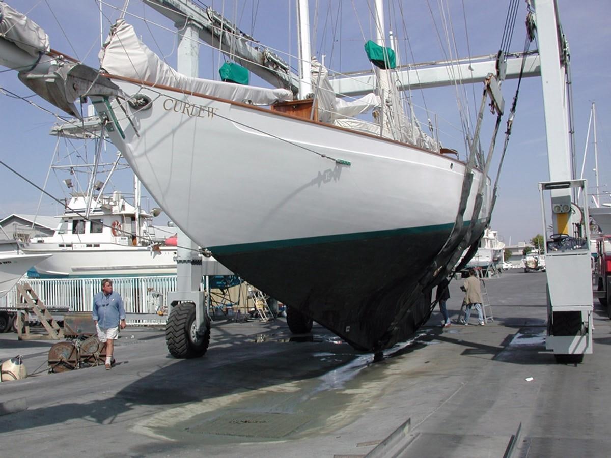 a large boat is parked in a dock aboard CURLEW Yacht for Sale