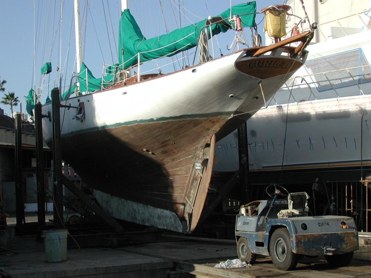 a large boat with a large piece of machinery in front of it aboard CURLEW Yacht for Sale