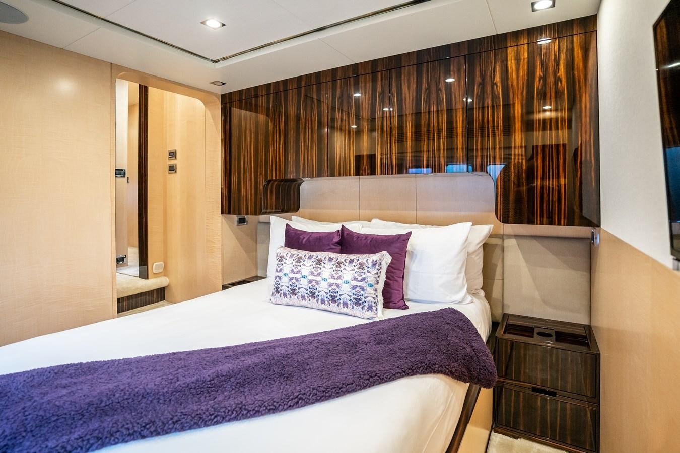 a bed with purple and white sheets aboard Valere Yacht for Sale