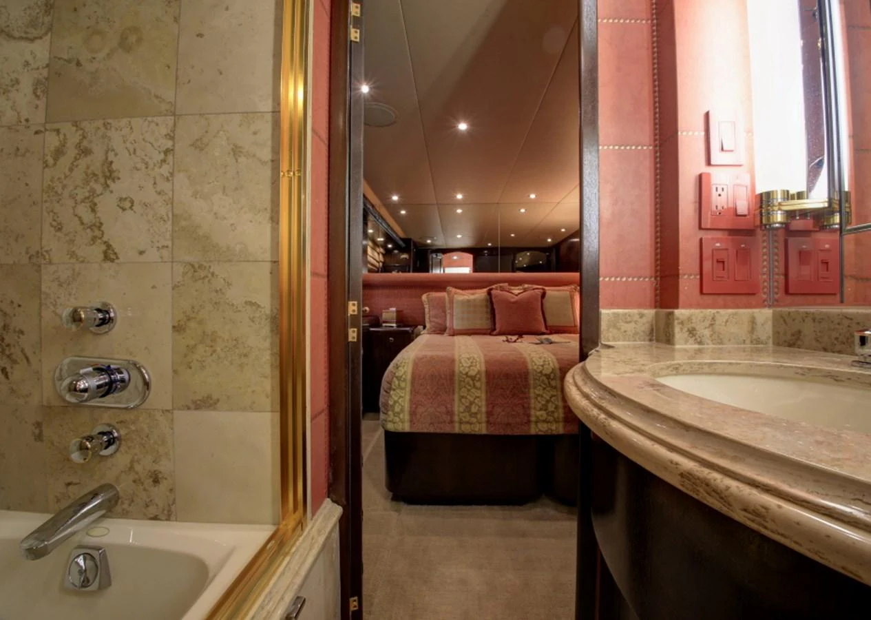 a bathroom with a sink and a bed aboard SUNDAY MONEY Yacht for Sale