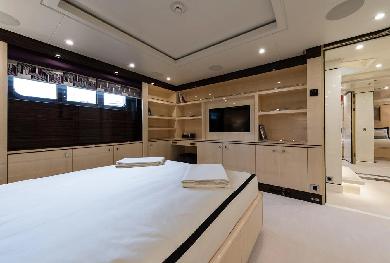 a room with a large table and tv aboard LILI Yacht for Charter