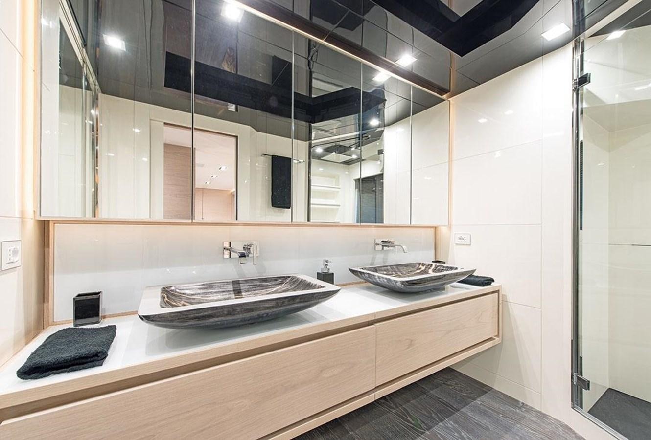 a bathroom with a sink and a phone on the counter aboard FAST & FURIOUS Yacht for Sale