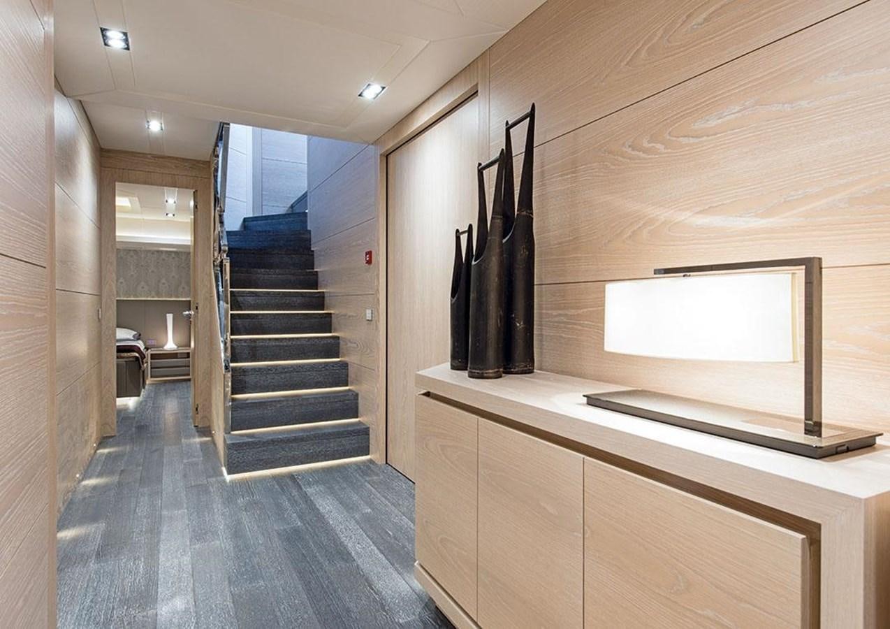 a room with a staircase and a tv aboard FAST & FURIOUS Yacht for Sale