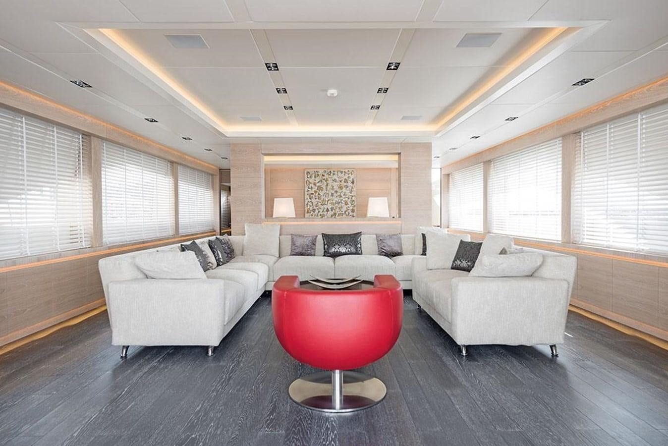 a living room with a couch and a table aboard FAST & FURIOUS Yacht for Sale