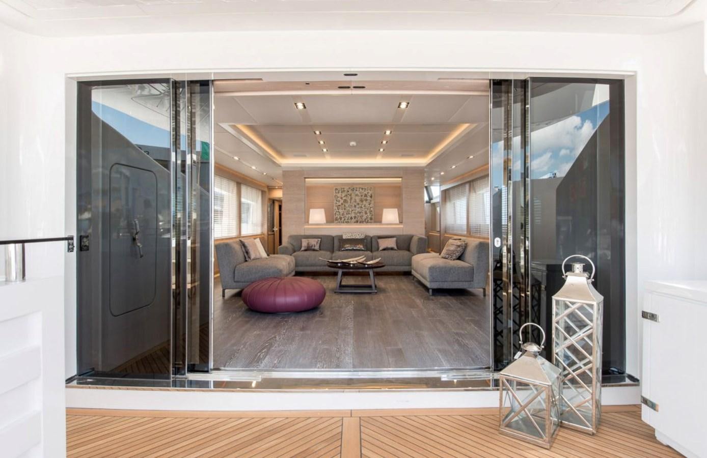 a living room with a large mirror aboard FAST & FURIOUS Yacht for Sale