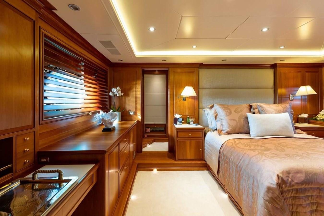 a bedroom with a bed and a desk aboard NORFOLK STAR Yacht for Charter