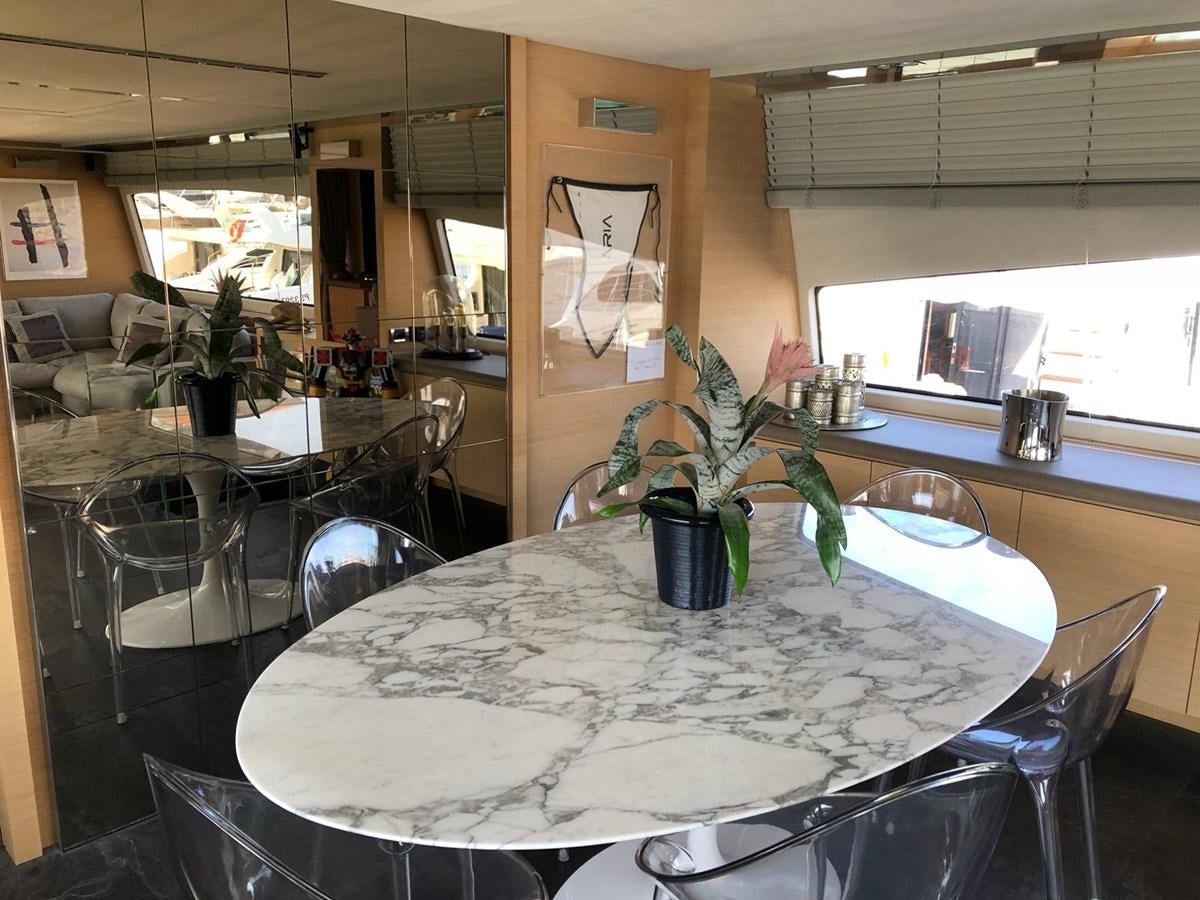 a table with chairs and plants aboard VISIONARIA Yacht for Sale