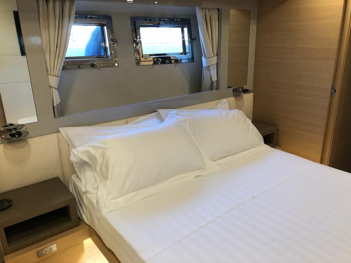 a bed with a television on the wall aboard VISIONARIA Yacht for Sale