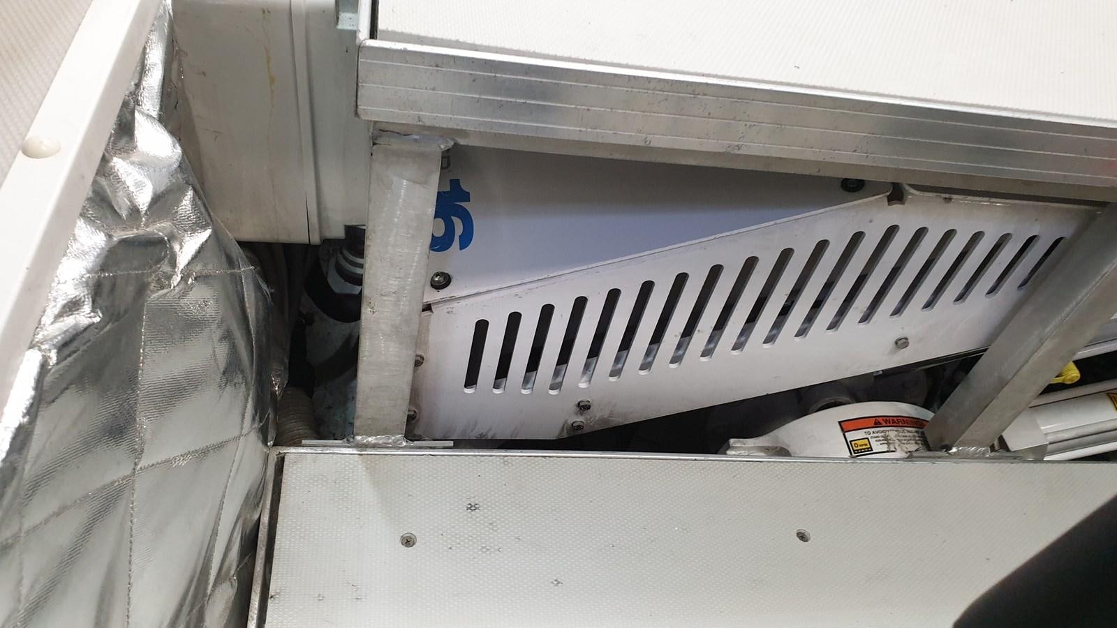 a white piano with a black and white keyboard and a red and white can on the keys aboard VISIONARIA Yacht for Sale