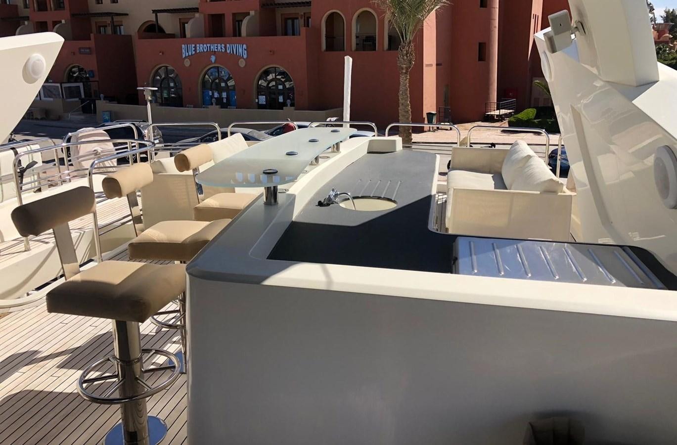 a room with tables and chairs aboard MI ALMA Yacht for Sale