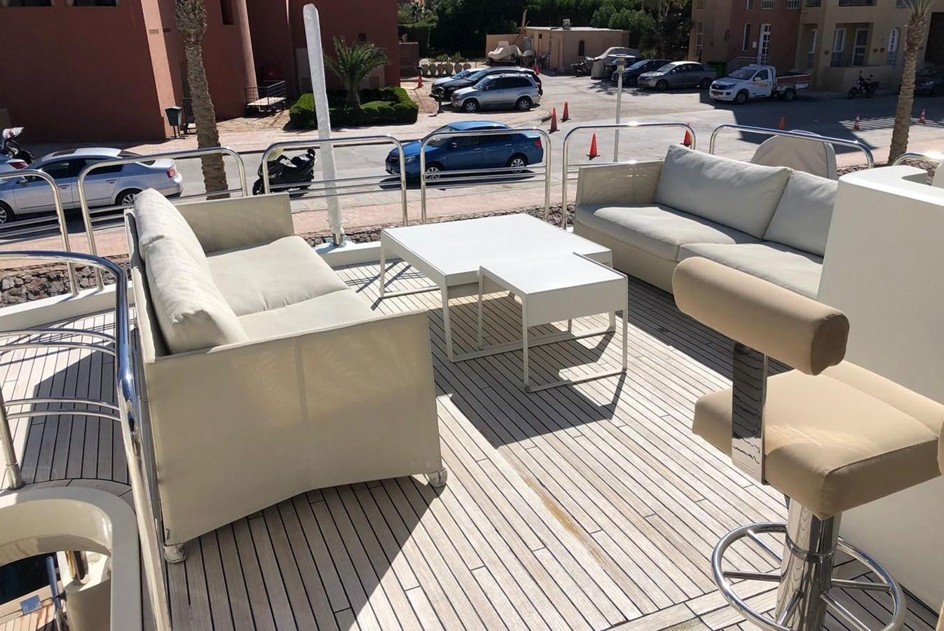 a table and chairs outside aboard MI ALMA Yacht for Sale