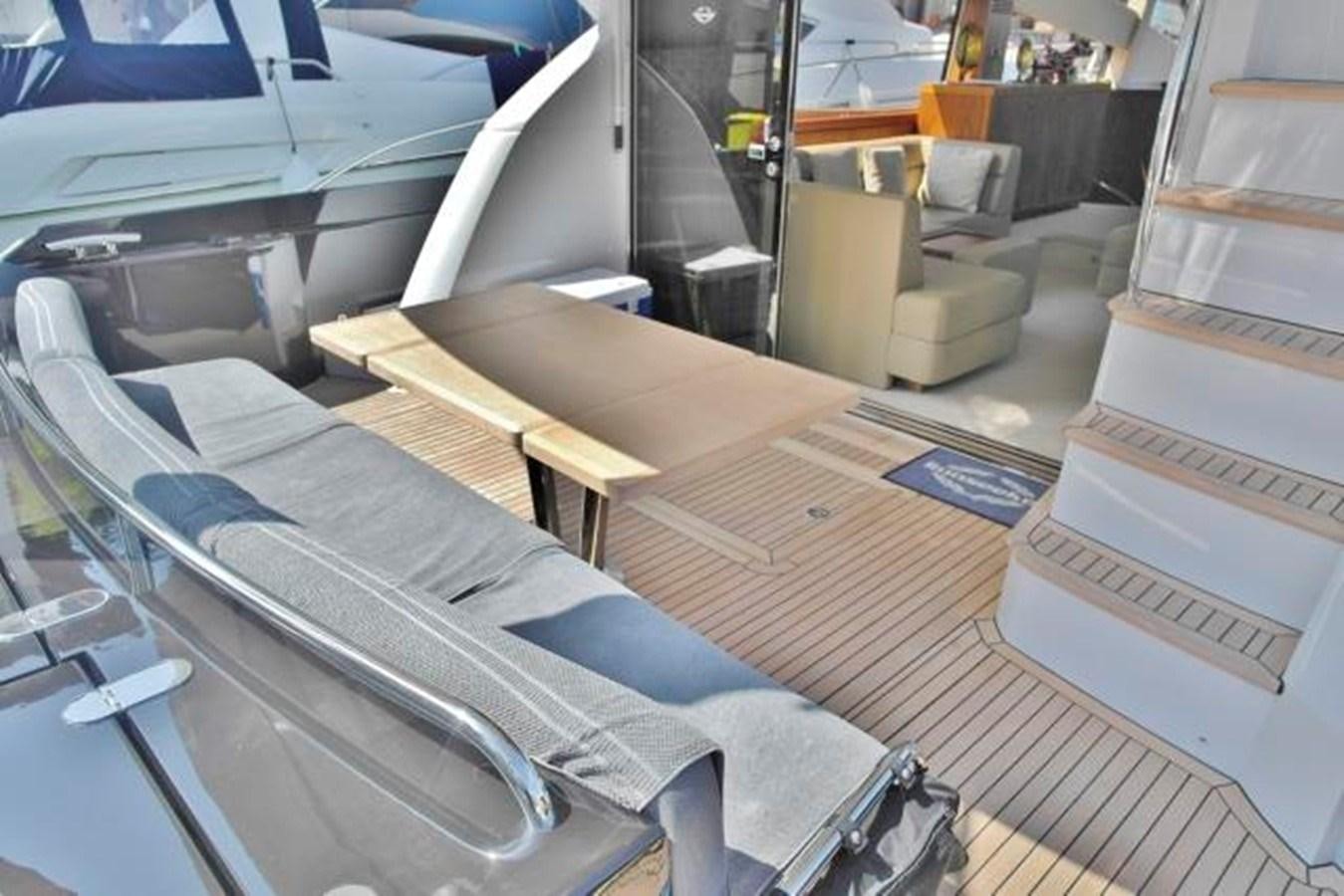 a room with a bed and desk aboard FARA Yacht for Sale