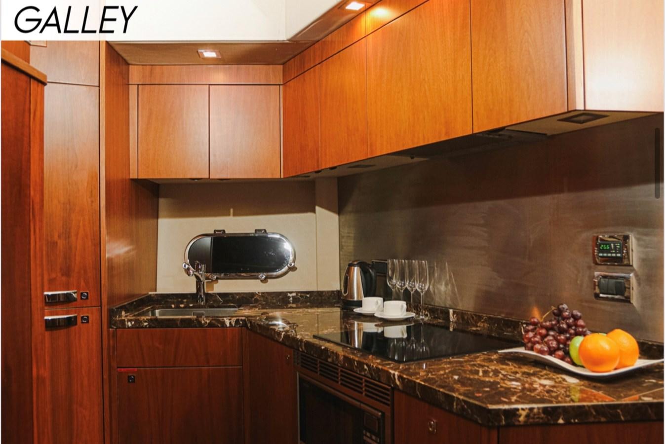 a kitchen with wooden cabinets aboard FARA Yacht for Sale