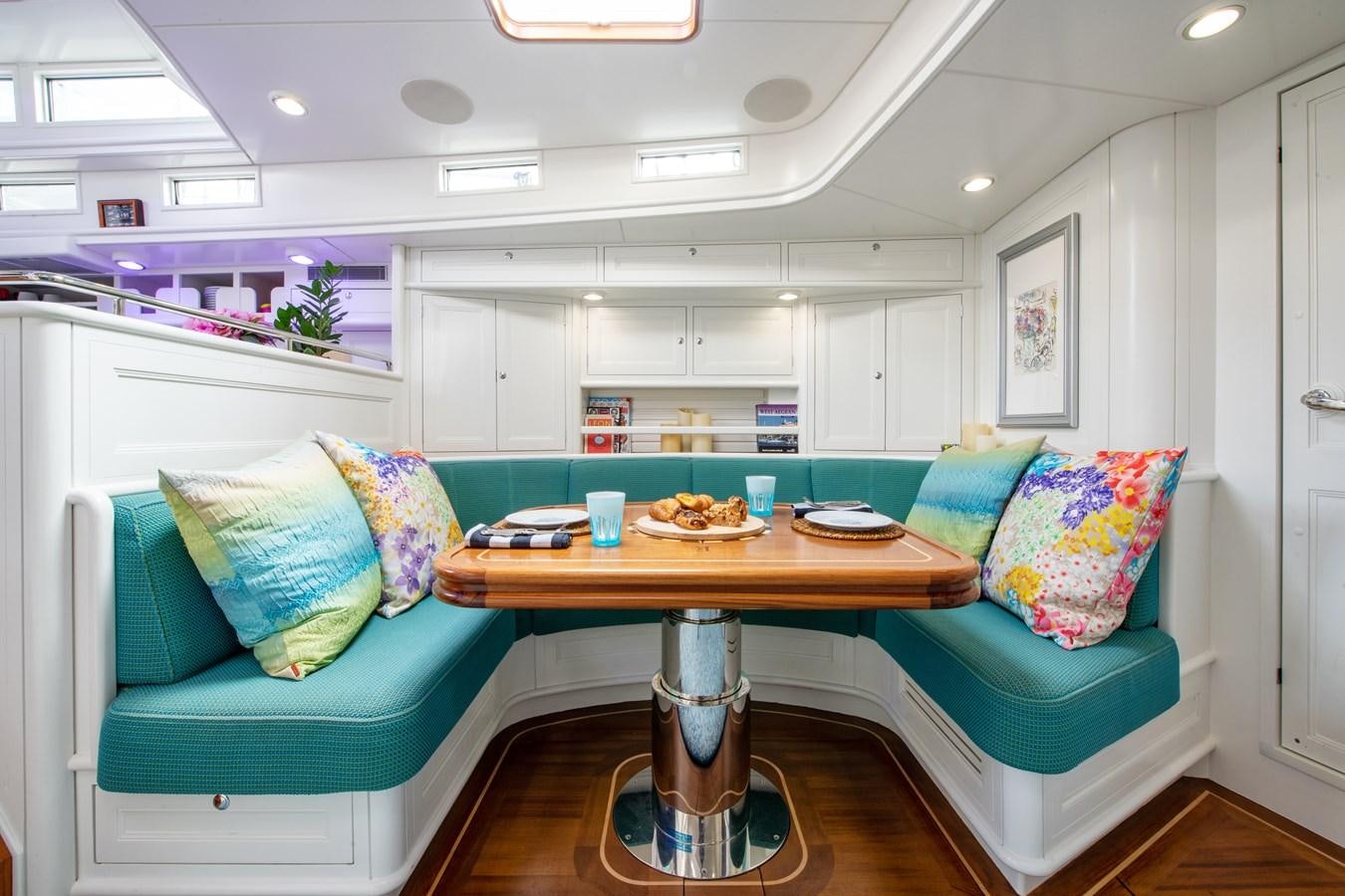 a living room with a blue couch aboard AMOENITAS Yacht for Sale