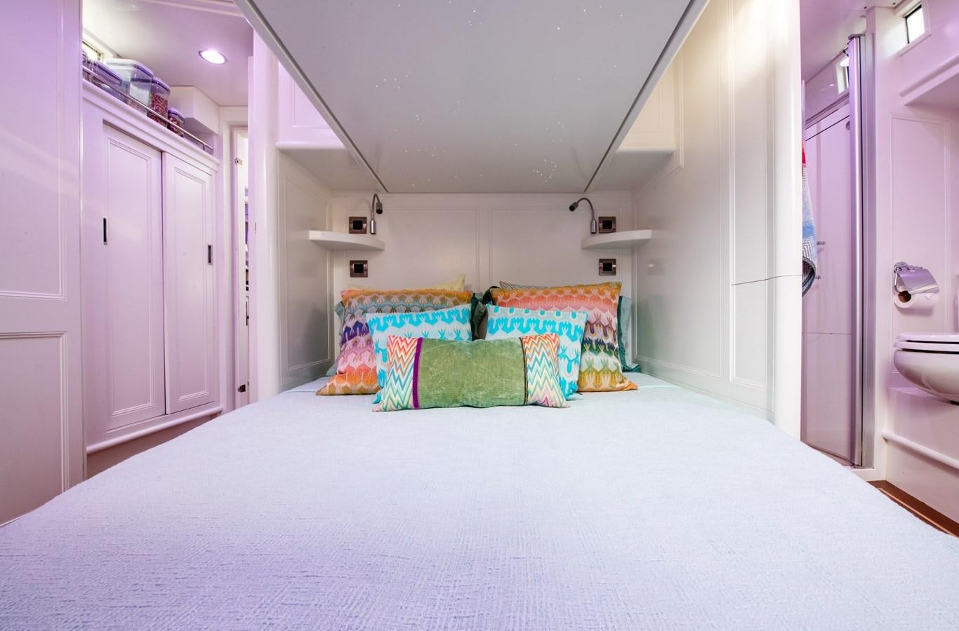 a bed with colorful pillows aboard AMOENITAS Yacht for Sale