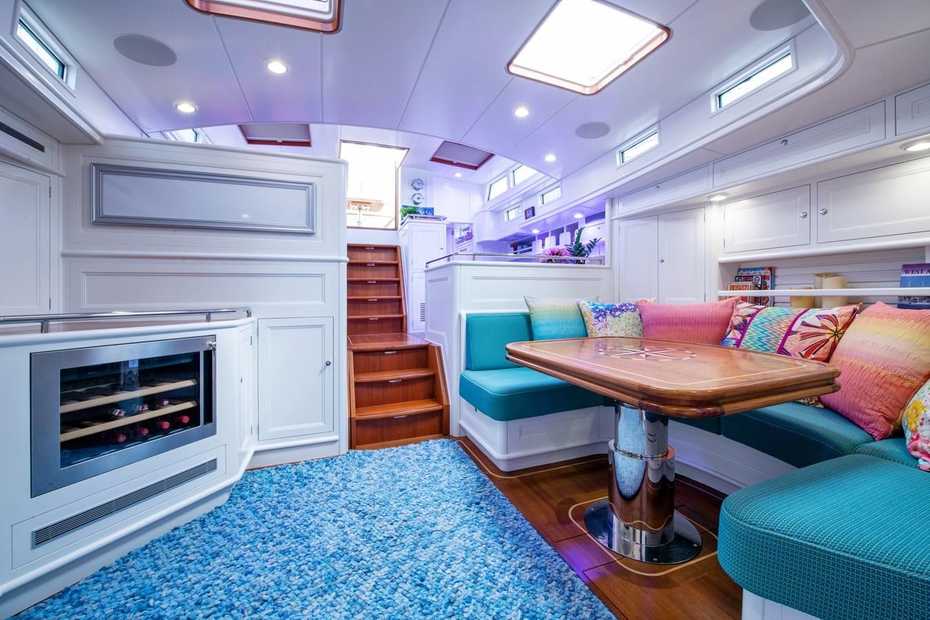a room with a table and a couch aboard AMOENITAS Yacht for Sale