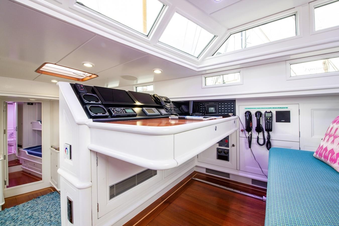 a white kitchen with black appliances aboard AMOENITAS Yacht for Sale