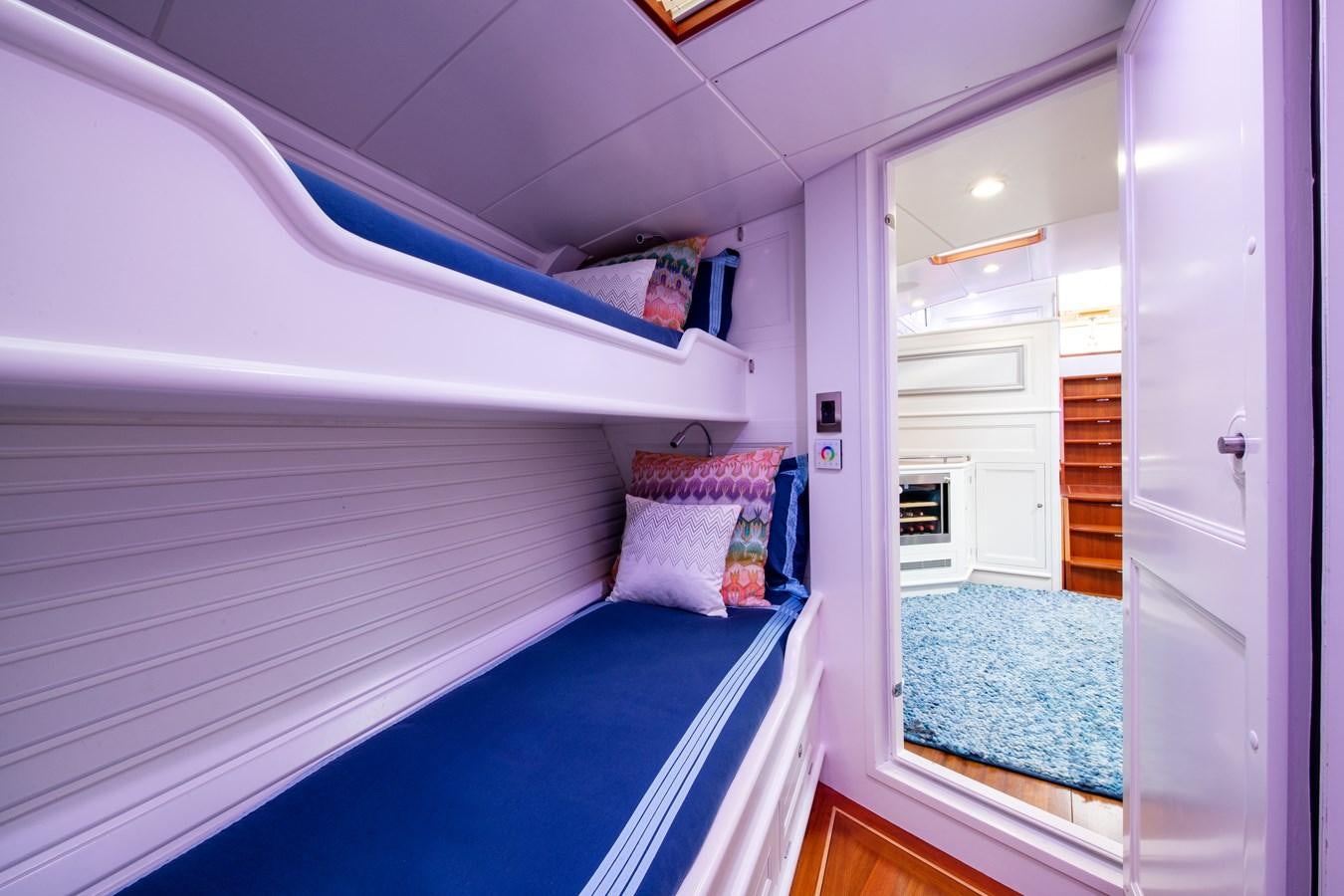 a bedroom with a blue bed aboard AMOENITAS Yacht for Sale