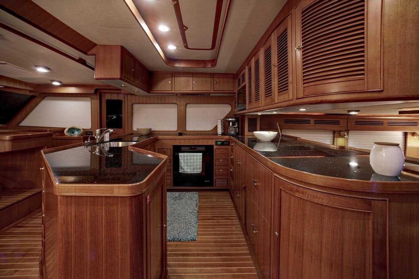 a kitchen with wooden cabinets aboard BEACH TO BEACH Yacht for Sale