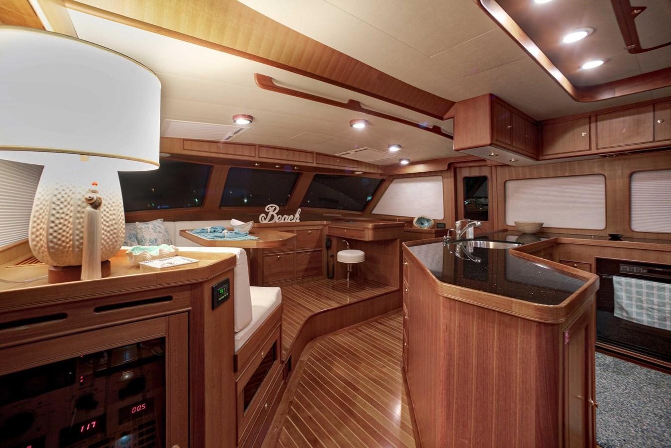 a kitchen with wooden cabinets aboard BEACH TO BEACH Yacht for Sale