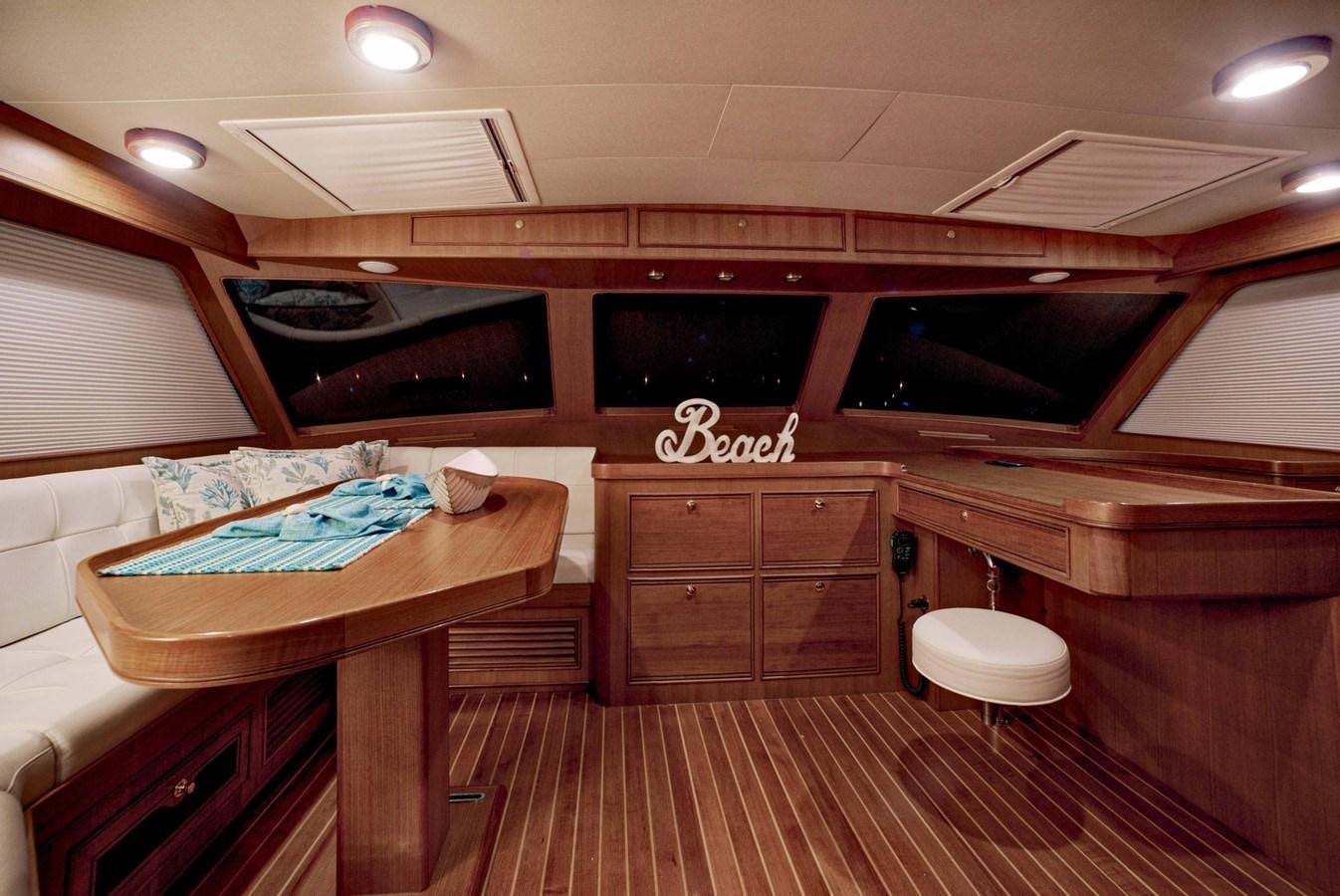 a room with a table and chairs aboard BEACH TO BEACH Yacht for Sale