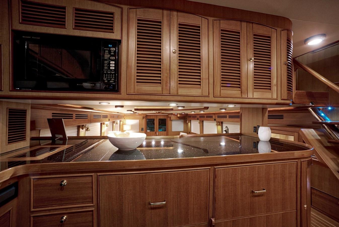 a kitchen with wooden cabinets aboard BEACH TO BEACH Yacht for Sale