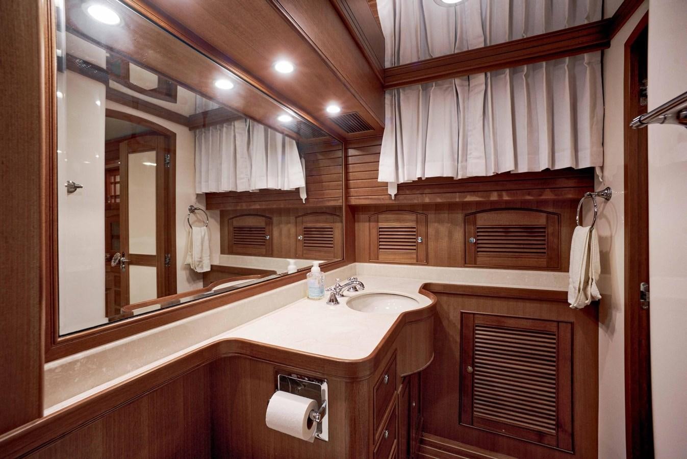 a bathroom with a sink and a mirror aboard BEACH TO BEACH Yacht for Sale