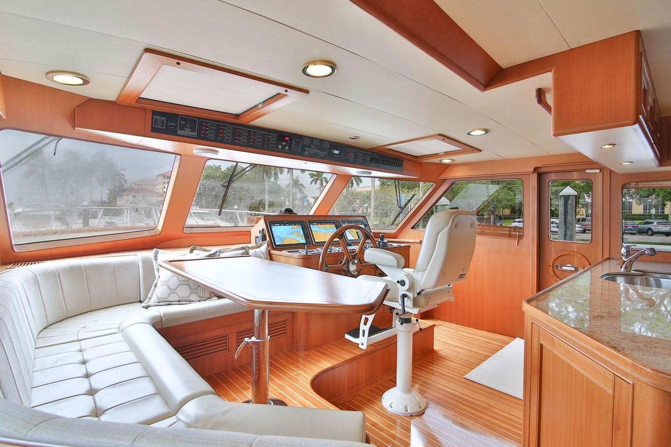 a boat with a table and chairs aboard FREQUENT SEA Yacht for Sale