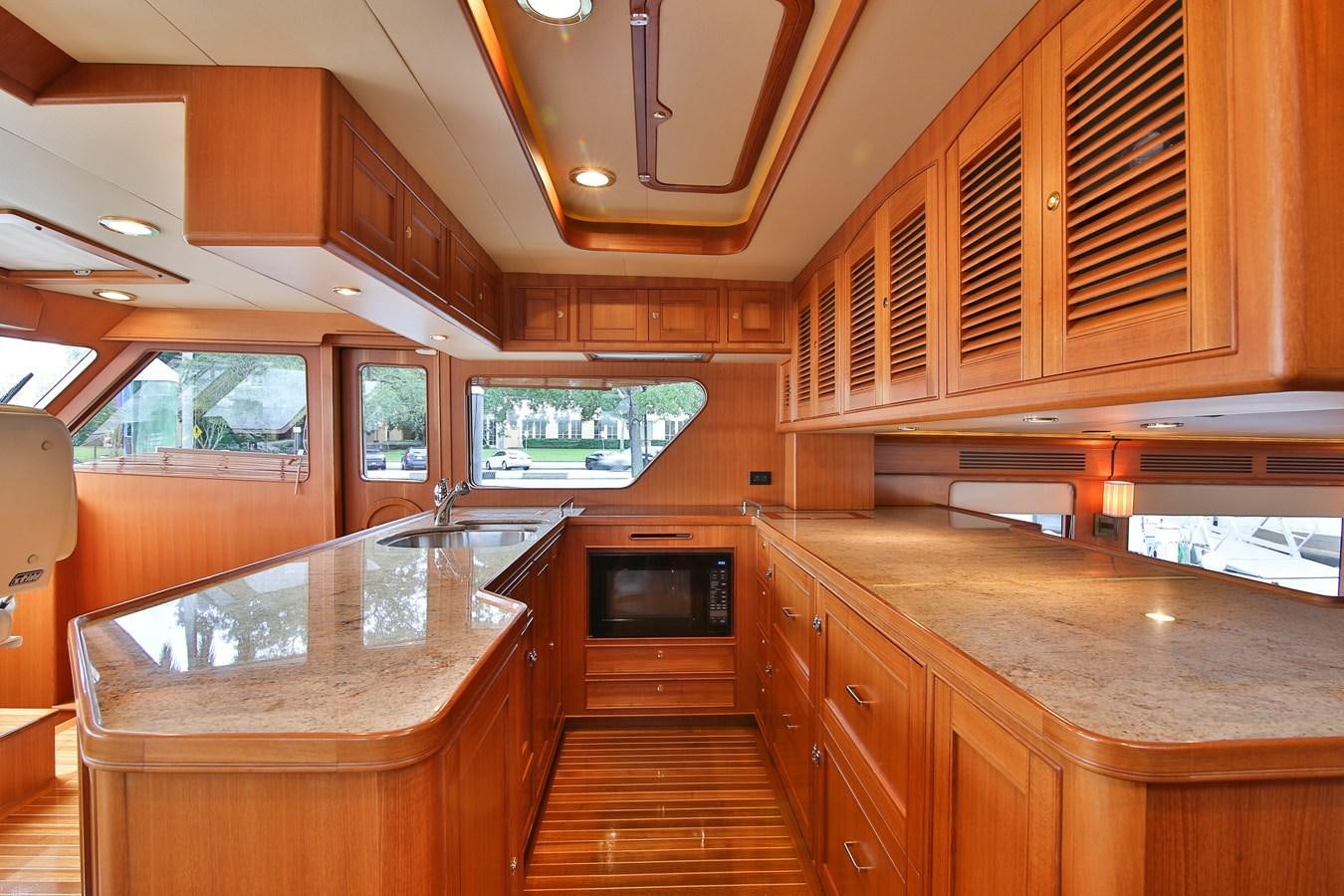 a kitchen with wooden cabinets aboard FREQUENT SEA Yacht for Sale