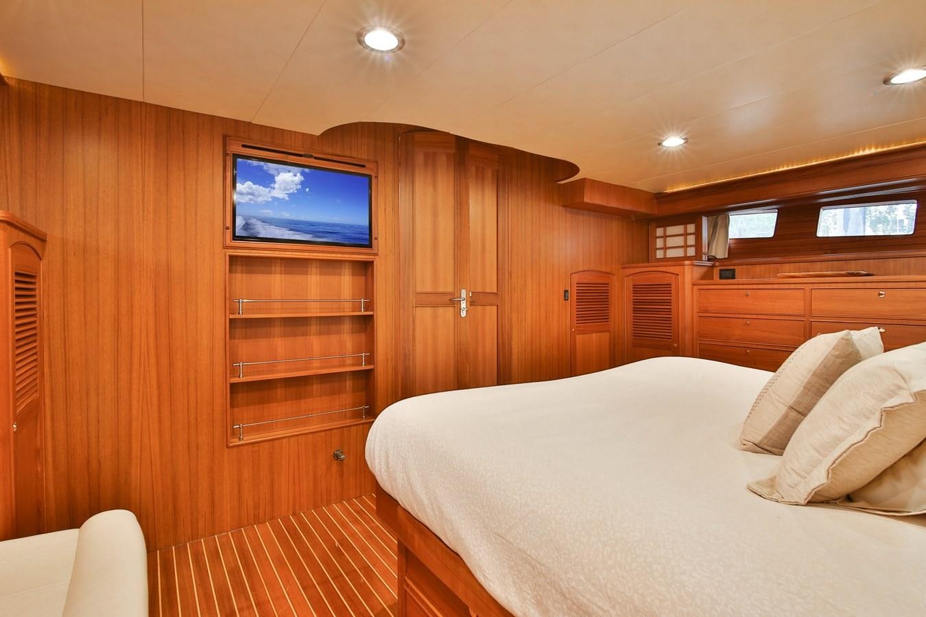 a bedroom with a tv on the wall aboard FREQUENT SEA Yacht for Sale