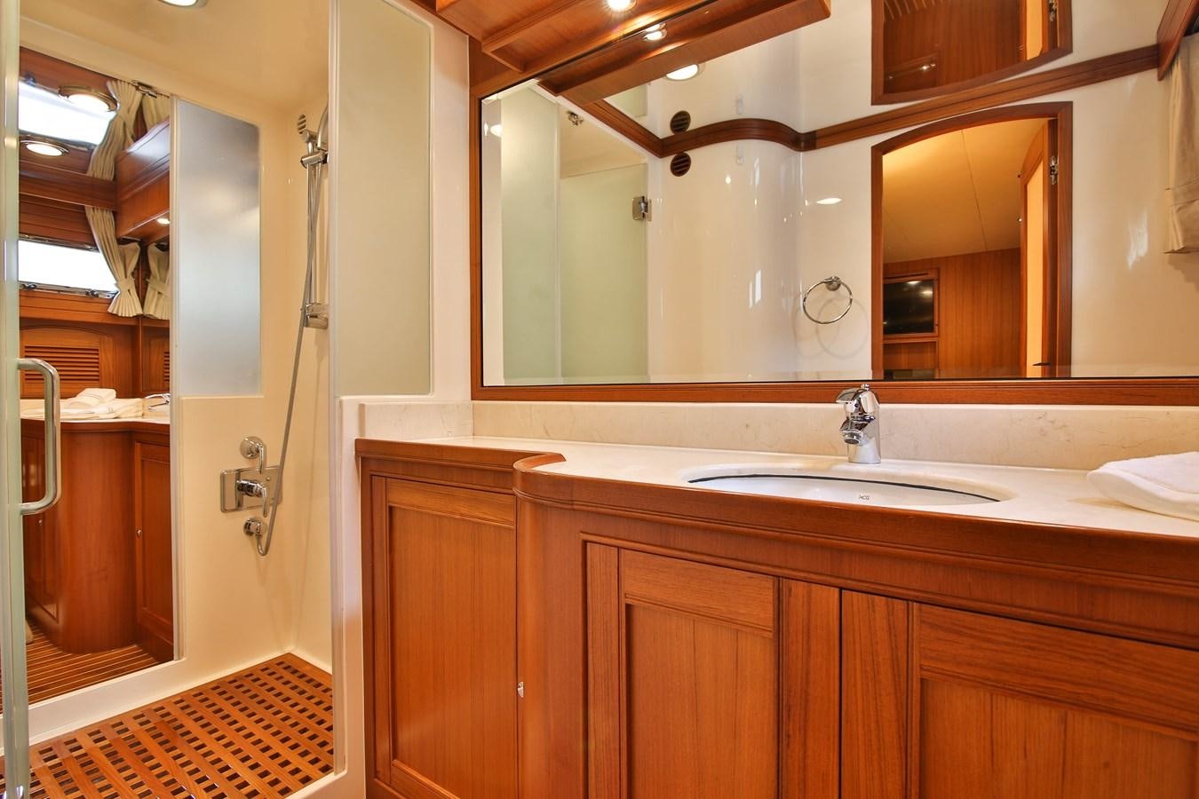 a bathroom with a sink and a mirror aboard FREQUENT SEA Yacht for Sale