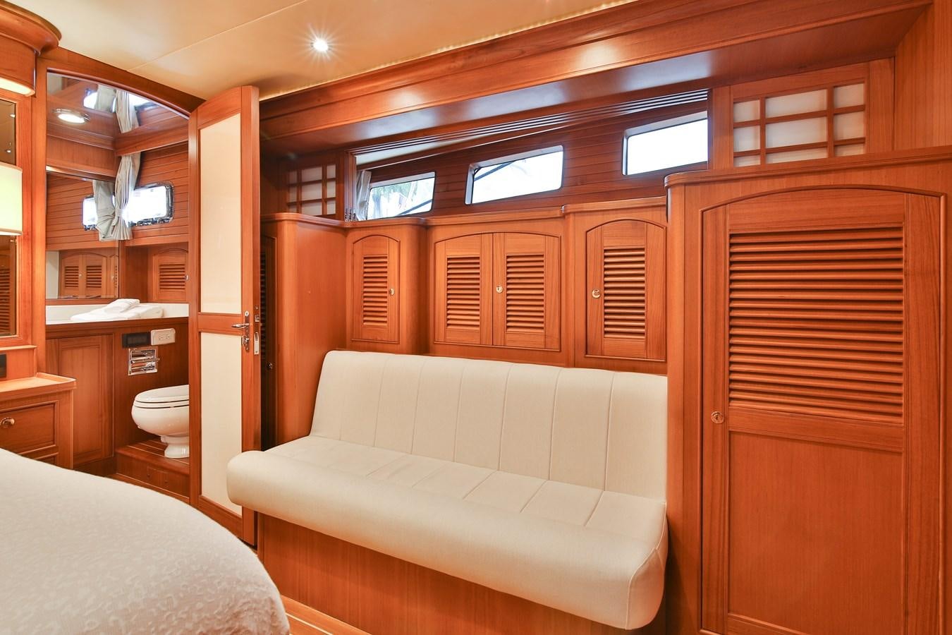 a room with a bed and a closet aboard FREQUENT SEA Yacht for Sale