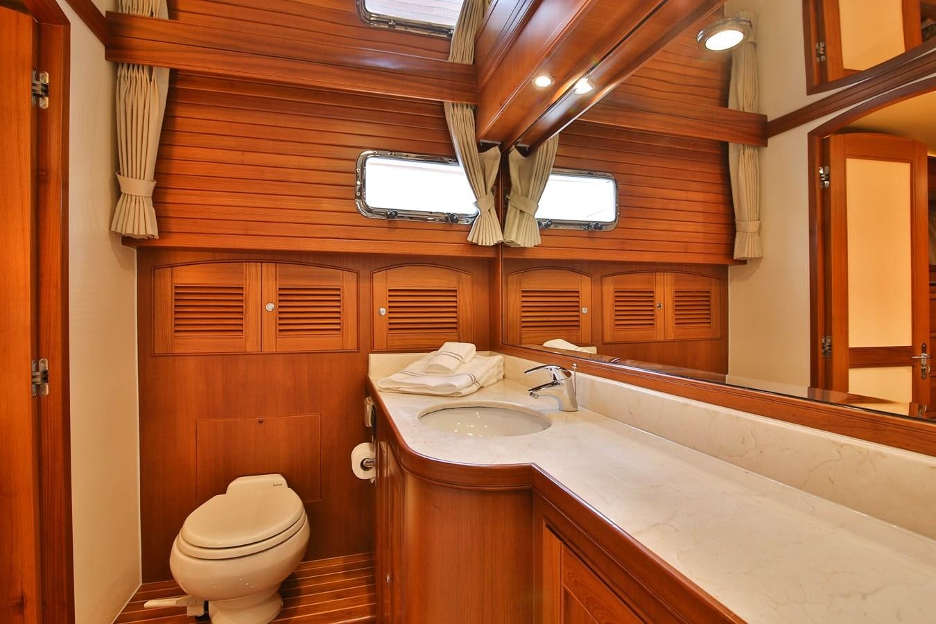 a bathroom with a sink toilet and a bathtub aboard FREQUENT SEA Yacht for Sale