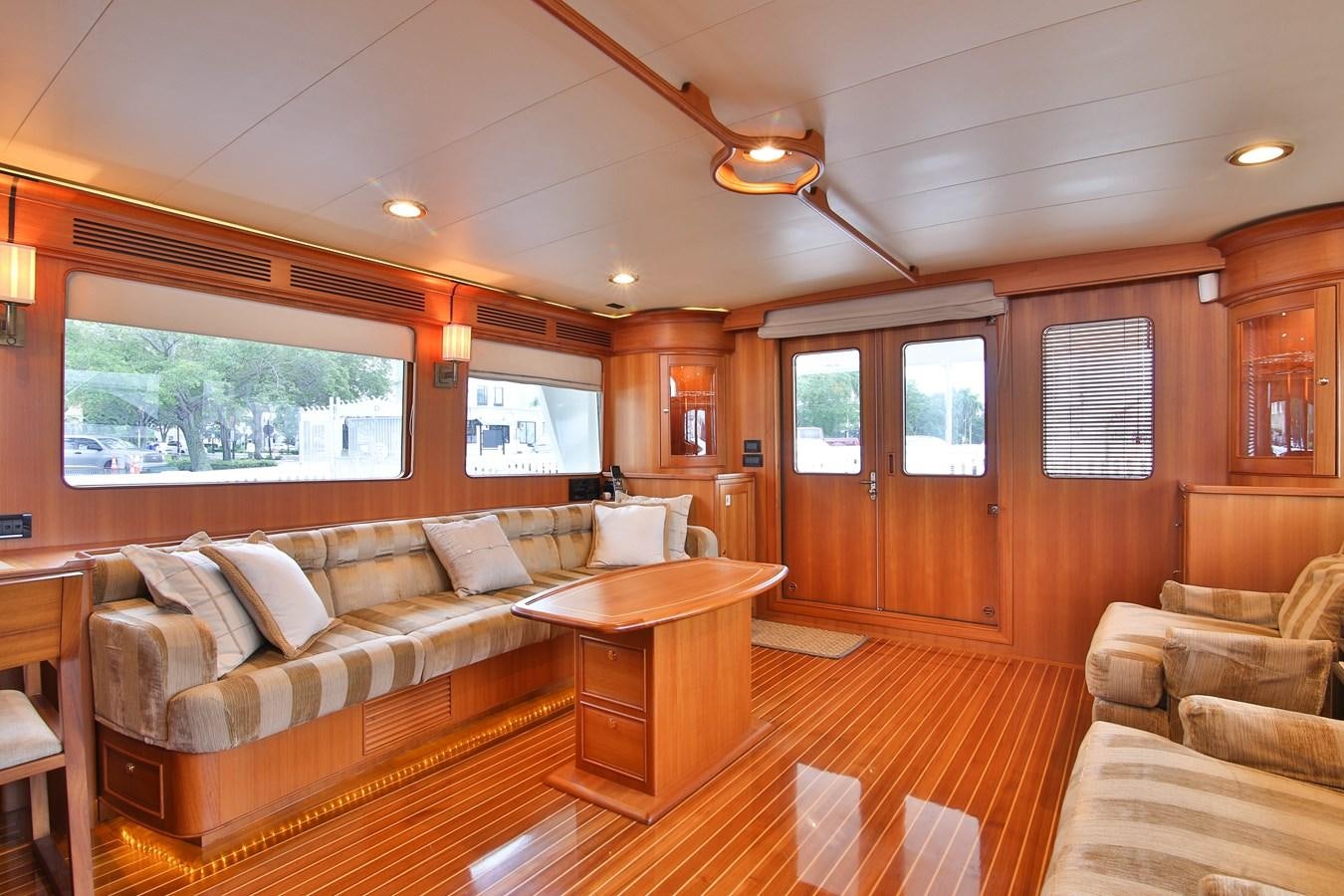 a living room with wood furniture aboard FREQUENT SEA Yacht for Sale