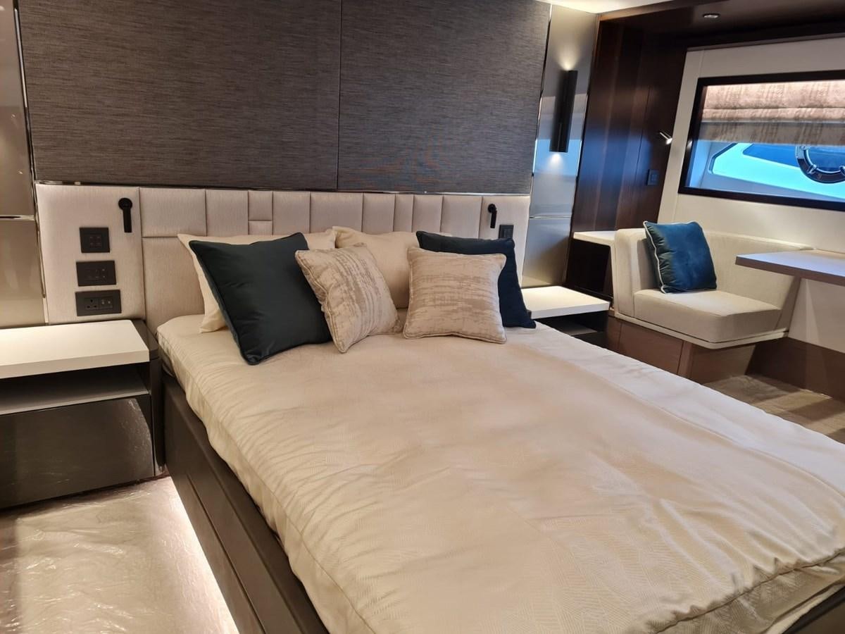 a bed with pillows and a chair aboard CANDY Yacht for Sale