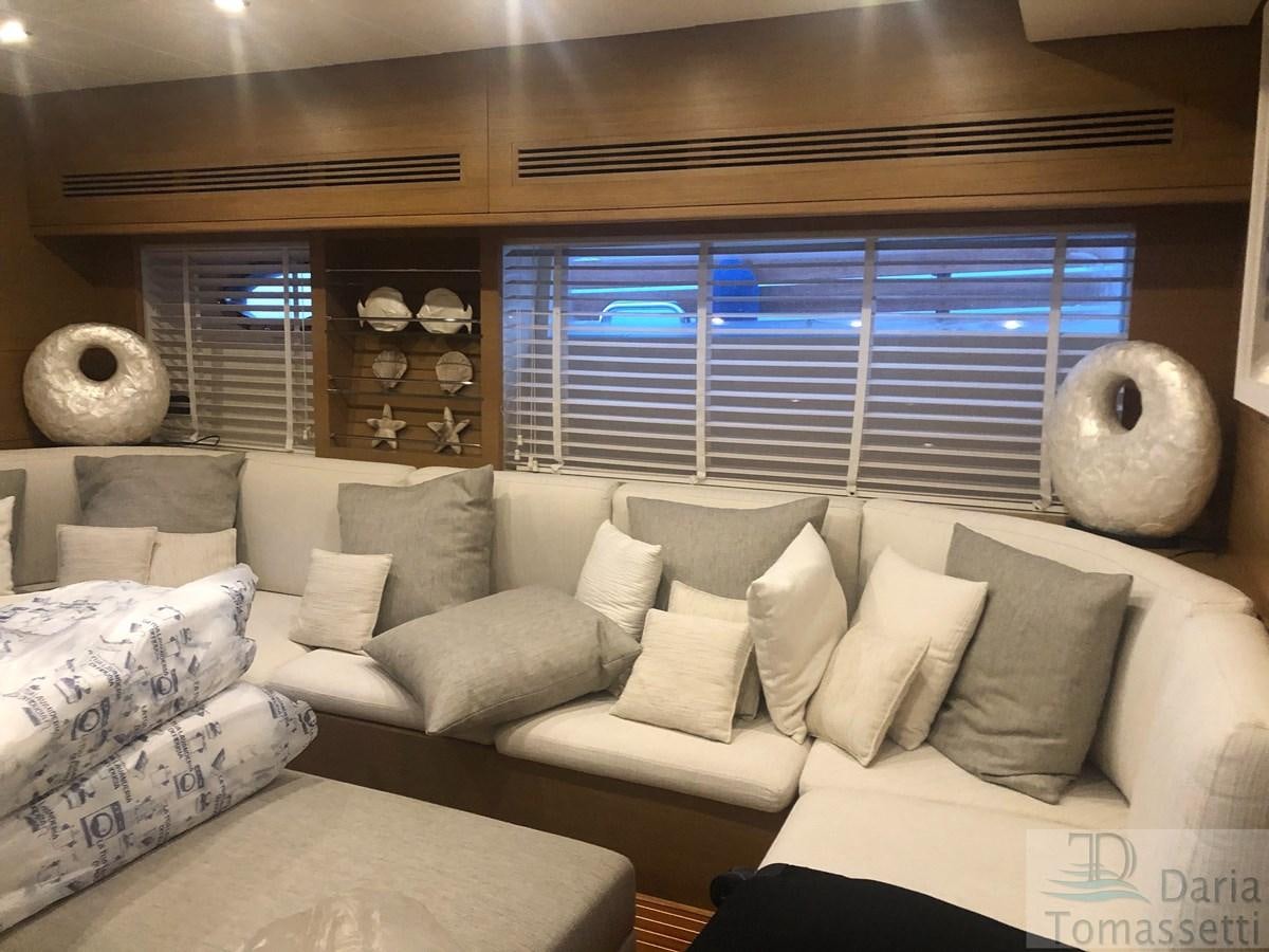 a living room with a large window aboard FB Yacht for Sale