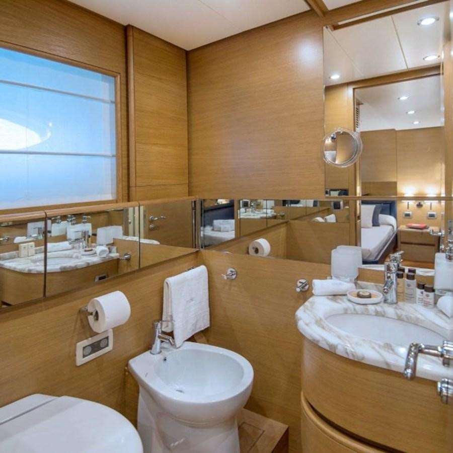 a bathroom with a large mirror aboard FB Yacht for Sale
