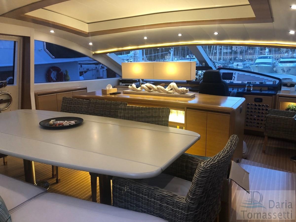 a room with a table and chairs aboard FB Yacht for Sale