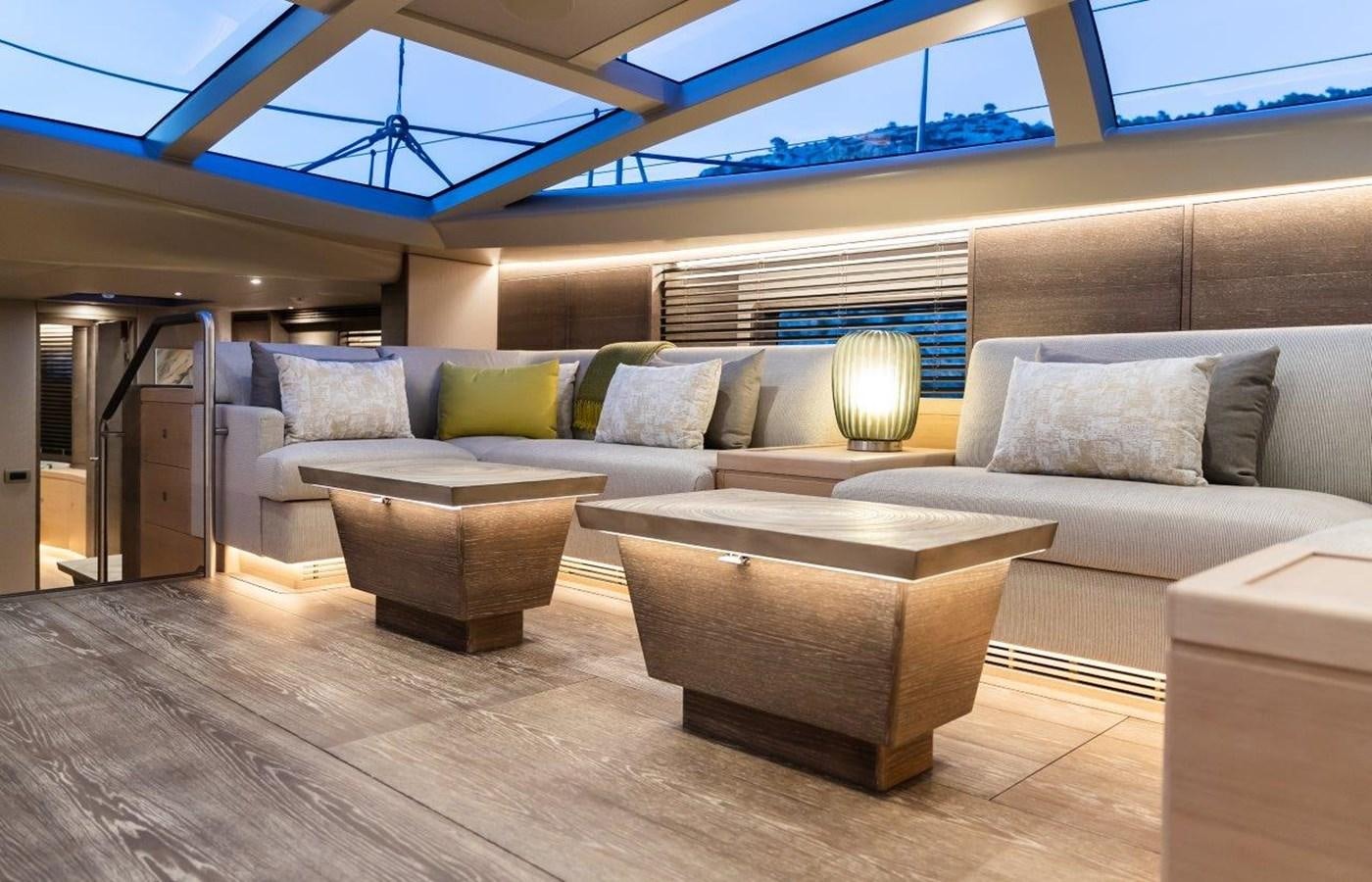 a living room with a couch and a large window aboard ALICE Yacht for Sale