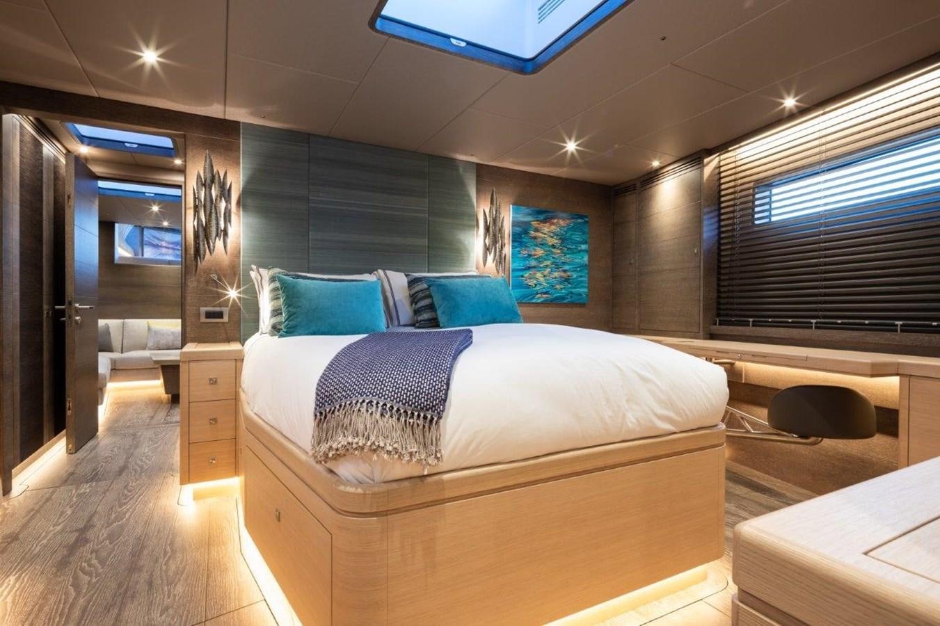 a room with a bed and a desk aboard ALICE Yacht for Sale